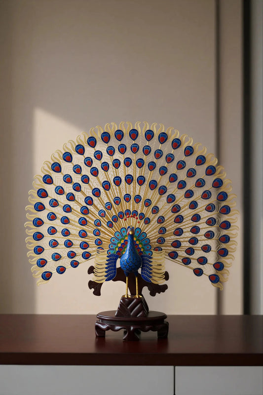 Exquisite handcrafted cloisonné enamel peacock statue with vibrant blue and green feathers, featuring intricate gold filigree work and a decorative base.